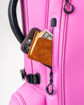 Bright pink Player Preferred Golf Bag featuring a zippered pocket with a wallet and cash for convenient storage.